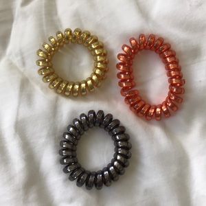 Black, gold and red hair tie coils